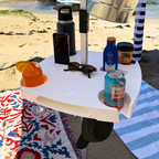 Beachside table with drinks, sunscreen, and sunglasses on a sandy beach.