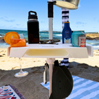 Beachside table with drinks and snacks on a sandy beach with ocean view